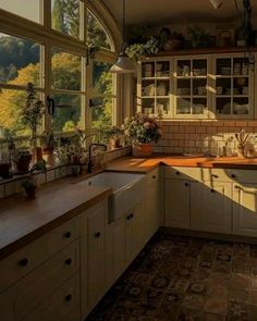 a kitchen filled with lots of windows next to a sink and stove top oven under a window