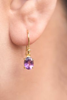 Our Amethyst Dangle Gold Earrings in 925 sterling silver & 18k gold vermeil are just the right size to be noticed and small enough to wear all day comfortably. Makes best gift for any occasion such as birthday, anniversary, Christmas or self gift. Sold as a pair, comes with silicone ear backs to keep them secure all day long. DETAILS * Stone size - 8mm x 6mm * Total length - 22mm * Materials - 18k thick gold vermeil over 925 sterling silver (hypoallergenic), Genuine Amethyst Gemstone * Sold as p Dainty Purple Gemstone Earrings, Oval Amethyst Earrings For Gift, Classic Amethyst Drop Earrings, Classic Amethyst Drop Earrings Jewelry, Purple Fine Jewelry Earrings For Gift, Amethyst Birthstone Drop Earrings, Large Moonstone Ring, Minimal Gifts, Amethyst Gold