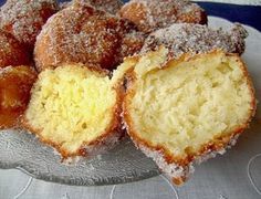 a plate topped with donuts covered in powdered sugar