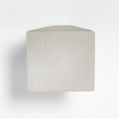 a white square shaped object on a wall