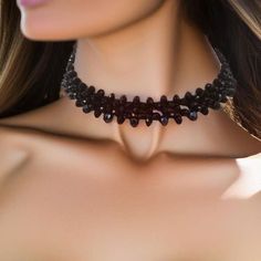 This Black Crystal Choker is a exquisite accessory is a fusion of elegance and mystique, designed to adorn your neckline with a touch of dark sophistication. Crafted meticulously, the choker comprises two layers of meticulously arranged black crystal rondelles, each 4mm and 6mm in size. These crystals have been carefully selected to create a mesmerizing play of light and shadows, ensuring that the choker sparkles with every subtle movement you make. The moment you shift, the choker comes alive w Bohemian Jewelry For Halloween Party, Bohemian Halloween Party Jewelry, Gothic Black Necklace With Black Beads, Adjustable Gothic Choker For Costume Party, Witchy Black Choker For Gift, Elegant Adjustable Jewelry For Costume Party, Gothic Black Beads Jewelry For Halloween, Gothic Black Beads Halloween Jewelry, Adjustable Black Vampire Style Necklaces