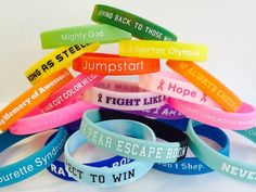 several bracelets with words on them sitting next to each other