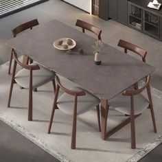 a dining table with four chairs and a plate on the table in front of it