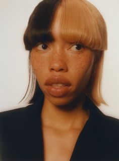 a woman with freckles on her face is making a funny face for the camera