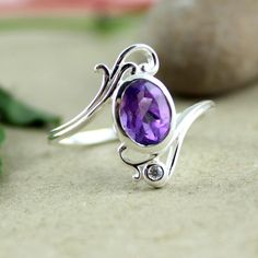 Funky Dainty ringof genuine gemstone,Amethyst tinted with single CZ is made of solid 925 sterling silver.All time wear women,s silver jewelry.Promise ring gift for your girl friend or a surprise gift for your Wife.This Mother's day a cute little ring for Mom.It is an affordable and comfortable ring to become my favorite ring. MR1005 SKU - R28019 MR1005 Style - Cocktail Gemstone - Natural Amethyst Metal - 92.5 % Solid Sterling Silver Weight- 2.7 gm approx Ring Size - All Sizes Stone Size- 6x8 mm Faceted Ring, Silver Cocktail, Purple Rings, Blue Stone Ring, Amethyst Jewelry, Women Ring, Filigree Ring, Metal Work, Finger Ring