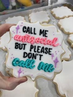 someone holding up a decorated cookie that says, call me an angelied but please don't care me