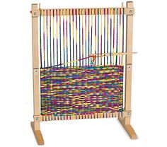 a wooden weaving machine with colorful yarn on it