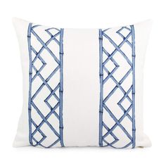 a blue and white pillow with decorative lines on the front, along with an embroidered back