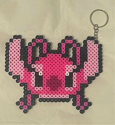 a pink and black beaded keychain with an image of a cartoon character on it