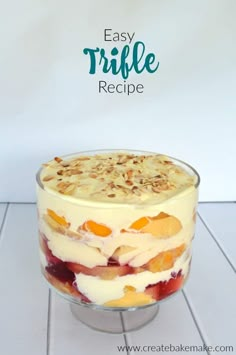 an easy trifle recipe with fruit and nuts in a glass dish on a white tile floor