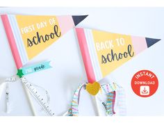 two paper pennants with the words first day of school and back to school on them