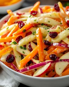 a white bowl filled with fruit and vegetables