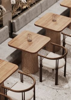 several wooden tables and chairs sitting next to each other