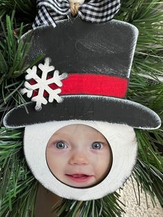 a child's christmas ornament hanging from a tree