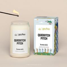 the harry potter quidditch pitch candle is next to an unopened box