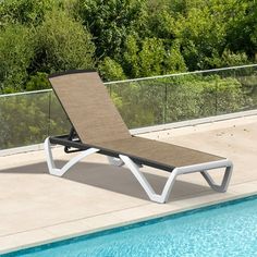 a lounge chair sitting next to a swimming pool