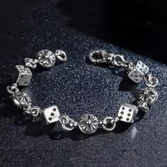 ✨ **Material & Size This vintage-style bracelet is crafted from high-quality chrome with playful dice charms. Coming In At 22cm (8.66inches to fit any wrist size). 🕹️ **Unique Features Perfect for fans of retro fashion and Y2K aesthetics. Each dice charm adds a fun and edgy touch, making it a stand-out piece. 🎁 **Care Instructions Easy to maintain. Simply wipe with a soft cloth to keep it shining. Ideal for gifting on special occasions or adding flair to your style. Masculine Jewelry, Streetwear Jewelry, Kang Ho Song, Retro Bracelet, Ball Bracelet, Casino Theme, Retro Jewelry, Jewelry Lookbook, Cross Bracelet