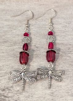 October "Tourmaline" just added!! Whimsical ** "birthstone" ** dragonfly charm earrings Each version is lovingly crafted with silver plated ear wires, beads, bead caps and Art Nouveau style dragonfly charms 🤗 Current variations are as follows: January: "Garnet" features pressed glass beads and faceted beads in rich dark maroon red February: "Amethyst" features sugilite stone beads, purple glass beads and glass pearls  March: "Aquamarine" features light blue sea sediment imperial jasper & glass Sugilite Stone, Art Nouveau Earrings, Art Nouveau Earring, Dark Maroon, Imperial Jasper, Dragonfly Charm, Earrings Art, Dragonfly Earrings, Birthstone Earrings