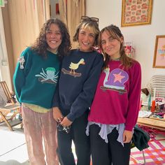 three girls are posing for the camera in their room