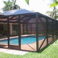 a pool enclosure in the middle of a yard