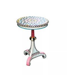 a small table with an artistic design on it's top and legs, sitting against a white background