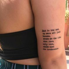 a woman with a tattoo on her arm that reads, and in the end we were all just humans