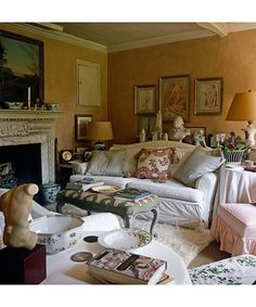 a living room filled with lots of furniture next to a fire place in a fireplace