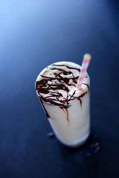 there is a drink with chocolate on the top and a straw sticking out of it