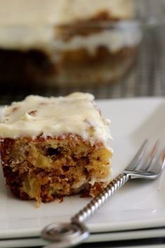 a piece of cake sitting on top of a white plate with a fork next to it