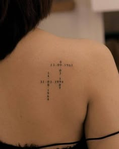 the back of a woman's shoulder with words written in cursive writing