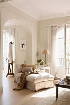 a living room filled with furniture and lots of windows