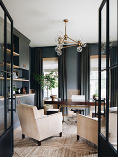 a living room filled with furniture and a chandelier