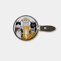 a round luggage tag with an image of cats in different colors and sizes on it