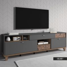 an entertainment center with a flat screen tv mounted on it's sideboard and drawers