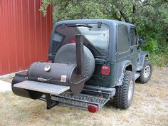 the back end of a jeep with a grill on it