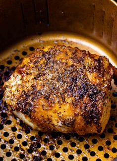 a piece of meat is cooking in a pan on the stove top with some oil