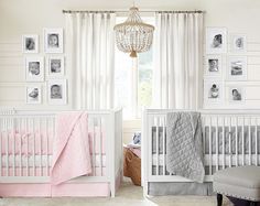 a baby's room with two cribs and pictures hanging on the wall