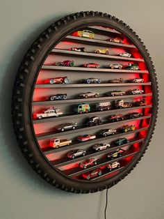 a clock made out of tire rims with cars on it