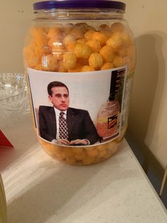 a jar filled with oranges sitting on top of a counter