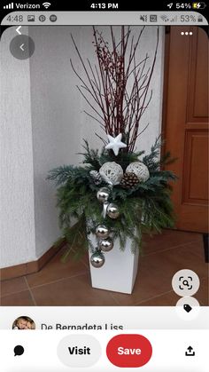 a white planter filled with christmas decorations