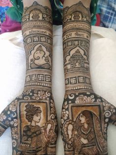 two hands with henna designs on them