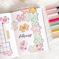 an open planner book with puzzle pieces on it and colored markers next to the pages