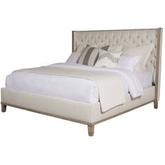 a bed with white linens and pillows on it's headboard, in front of a white background