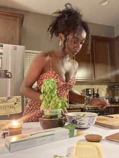 a woman is preparing food in the kitchen