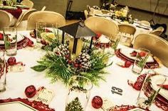 a table set for christmas dinner with place settings