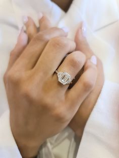 a person wearing a white shirt and a diamond ring