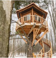 a tree house built in the woods with stairs