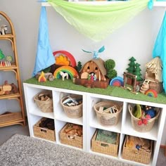 a room filled with lots of toys on top of a white shelf next to a wall