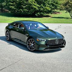 the mercedes amg gt is parked in a parking lot next to some green trees