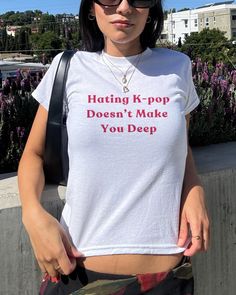 Embrace a bold statement with our "Hating K-pop Doesn't Make You Deep" tee! Perfect for those who want to showcase their unique perspective, this tee is a must-have for fans and non-fans alike. Whether you're rocking it as a K-pop crop top or styling it as a Y2K graphic baby tee, it's designed to make a statement. K-pop Tee: Show off your stance with this eye-catching design. K-pop Crop Top: For a trendy, fashionable look that's perfect for any casual outing. Y2K Crop Top & 90s Baby Tee: Embrace the nostalgia with a vintage vibe. K-pop Merch: A great gift for anyone who enjoys making a statement. Graphic Baby Tee: Ideal for those who love a bold and stylish statement. Care instructions - Machine wash: warm (max 40C or 105F) - Non-chlorine: bleach as needed - Tumble dry: medium heat - Iron, 90s Inspired Crop Top With Letter Print For Streetwear, Kpop Style Summer Top With Screen Print, 90s Inspired Letter Print Crop Top For Streetwear, White Kpop Style Tops With Letter Print, White Kpop Style Top With Letter Print, 90s Inspired Streetwear Crop Top With Letter Print, Y2k Style Crop Top With Funny Text, Summer Kpop Tops With Text Print, Y2k Style Funny Print Short Sleeve Crop Top